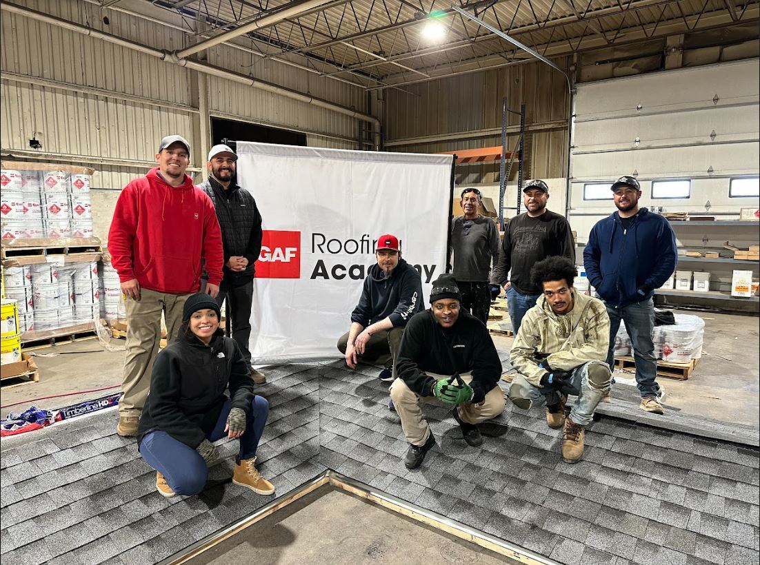 Kimberly with her roofing Academy class on the roof