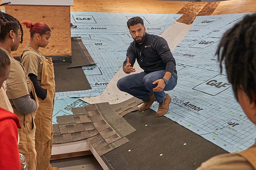 Dior Vass son a test roof speaking to GAF Roofing Academy students