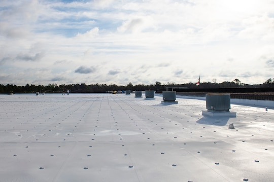 Commercial roof coating with sky in background