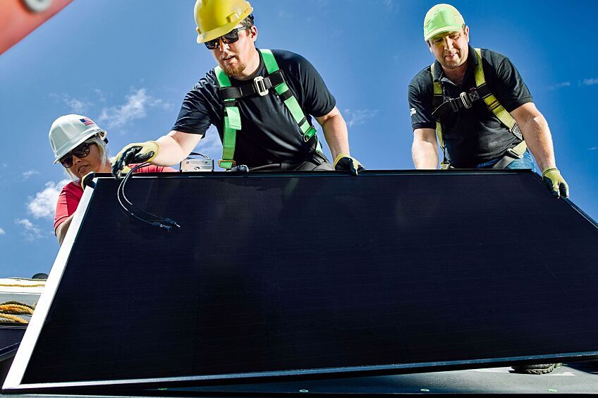 Contractors installing a solar roof