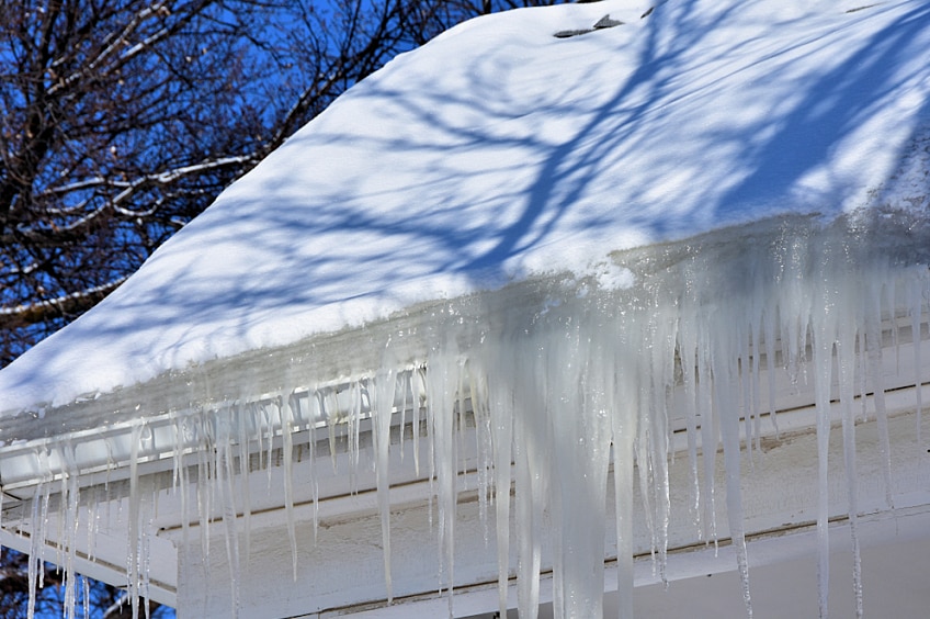 Icicles hanging from the edge of a roof.