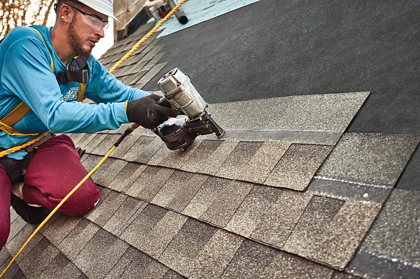 A side-by-side comparison of roof shingles before and after cleaning