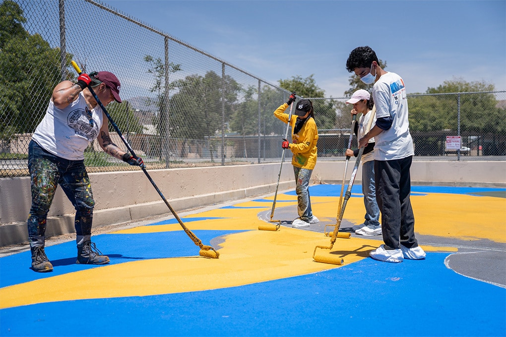 Volunteers Apply GAF StreetBond® pavement coatings with Invisible Shade in the Pacoima Neighborhood