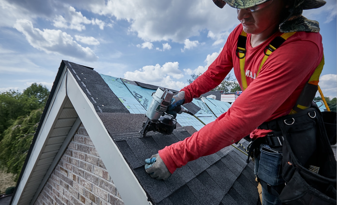 A Roofer Installing GAF AS II Shingles on a Roof
