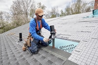 A roofer installs the GAF Master Flow™ Pivot™ Pipe Boot Flashing