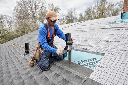 A roofer installs the GAF Master Flow™ Pivot™ Pipe Boot Flashing