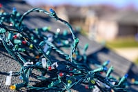 Tangled pile of Christmas lights on roof 