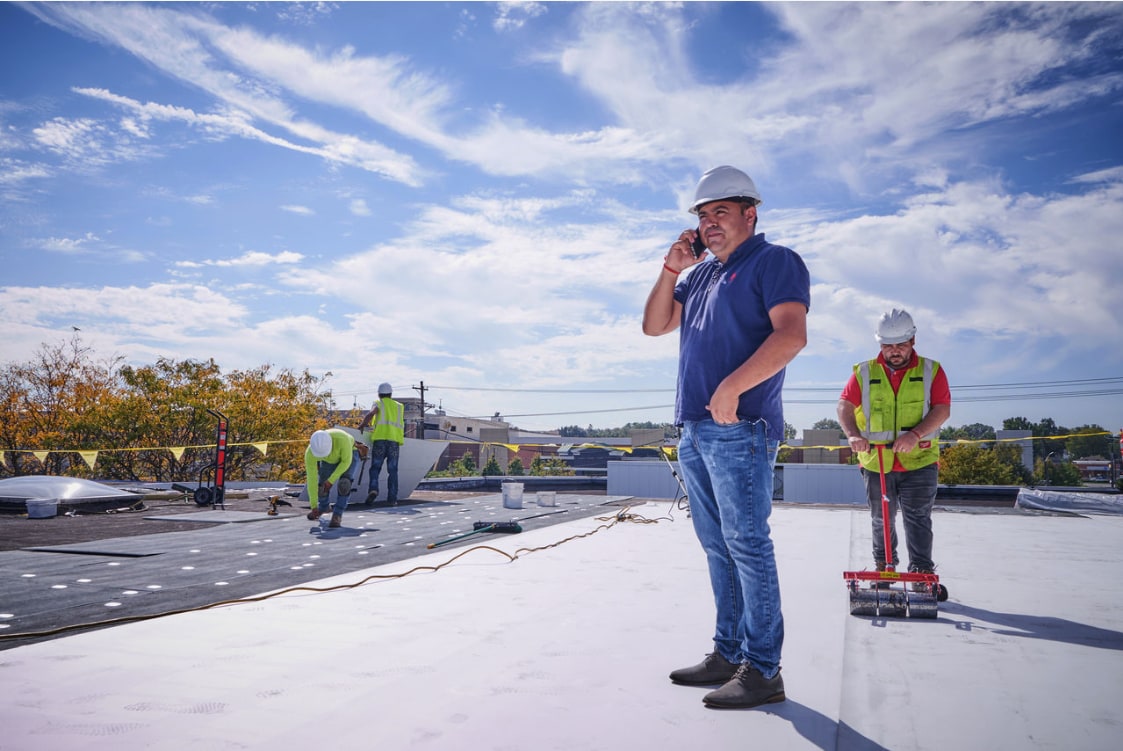 An architect inspects the roof of a commercial building