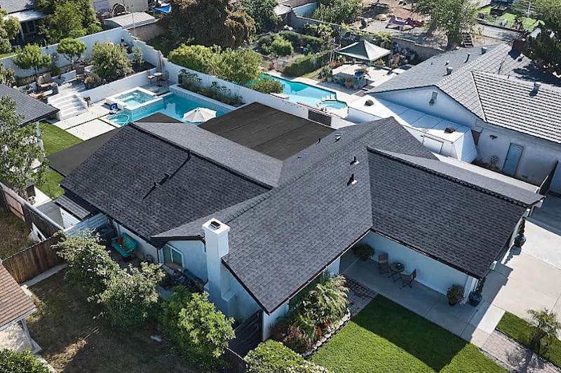 A large house with dark roofing shingles.