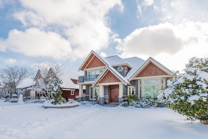 A typical american house in winter. Snow covered.