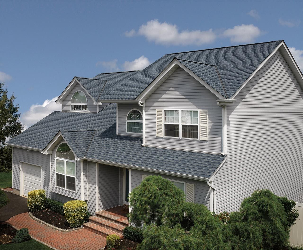 A house with GAF Timberline HDZ Biscayne Blue Roofing Shingles 