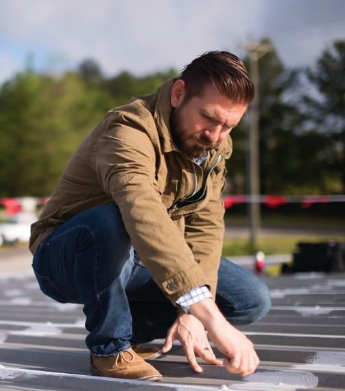 metal seam treatment A contractor checking metal seam treatment.