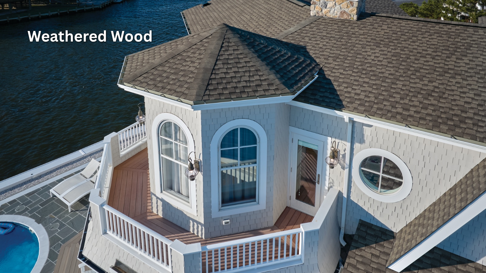 GAF Timberline UHDZ Shingles in the color Weathered Wood on the roof of a waterfront home. 