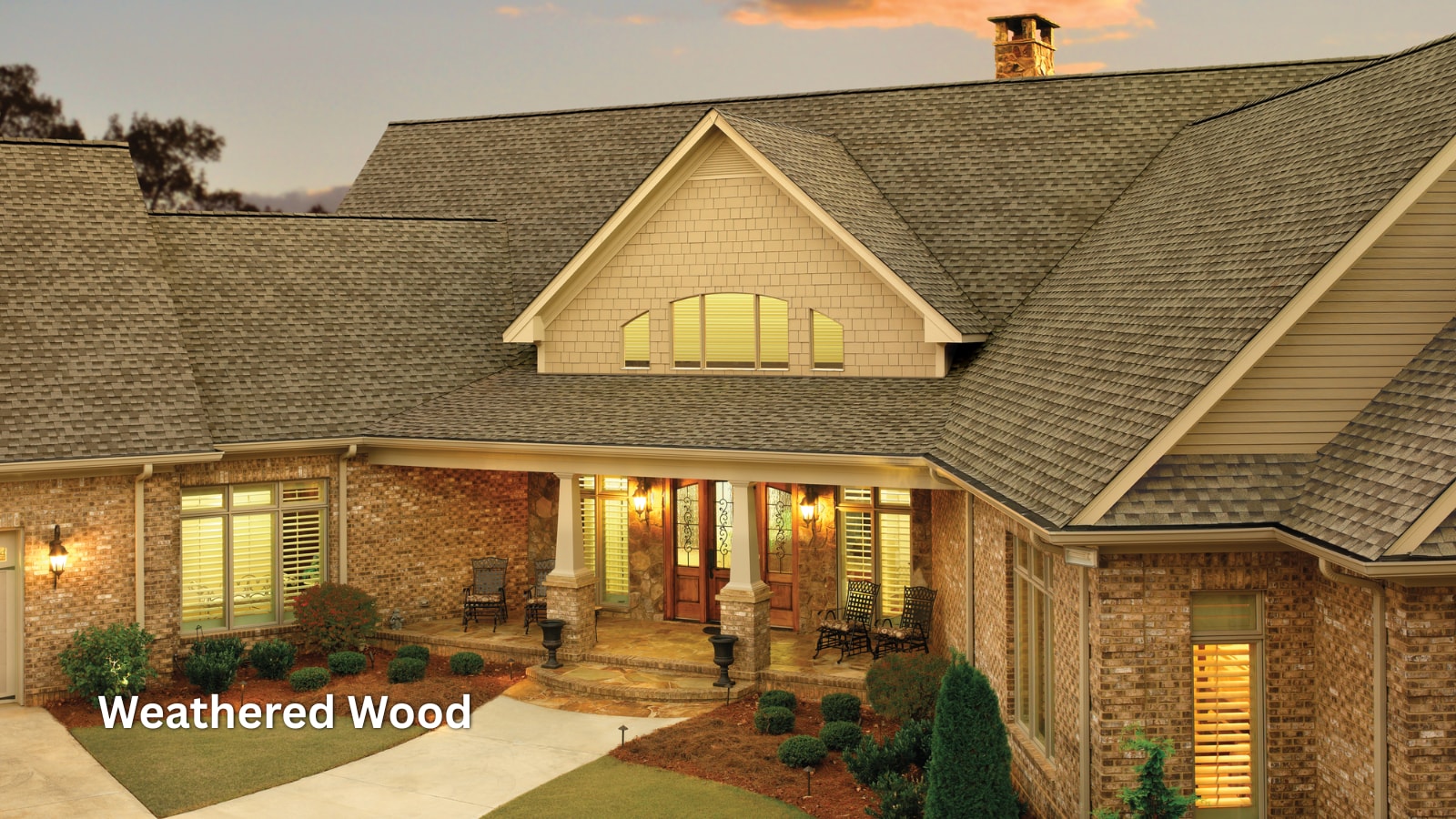 GAF Timberline HDZ shingles in the color Weathered Wood on the roof of a brick home. 