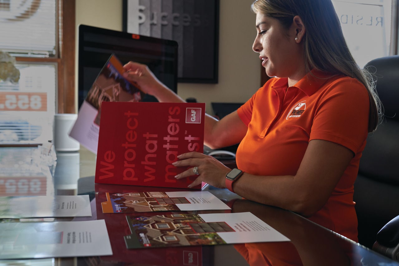 roofing professional reviewing educational materials from gaf Roofing Professional Reviewing Educational Materials from GAF