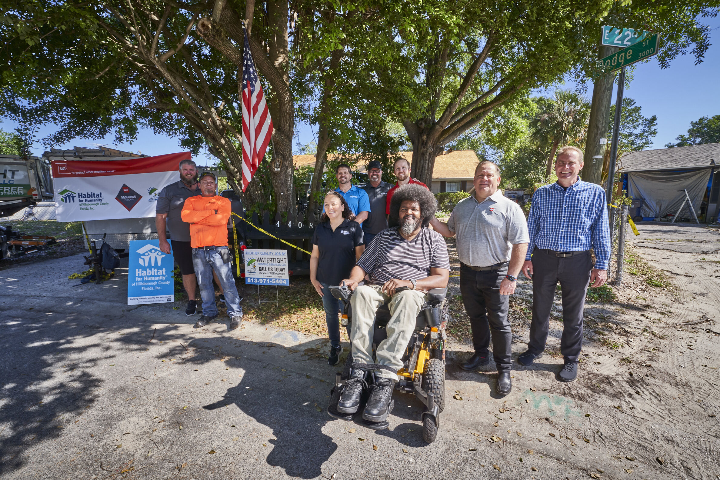 posing with GAF team in front of house
