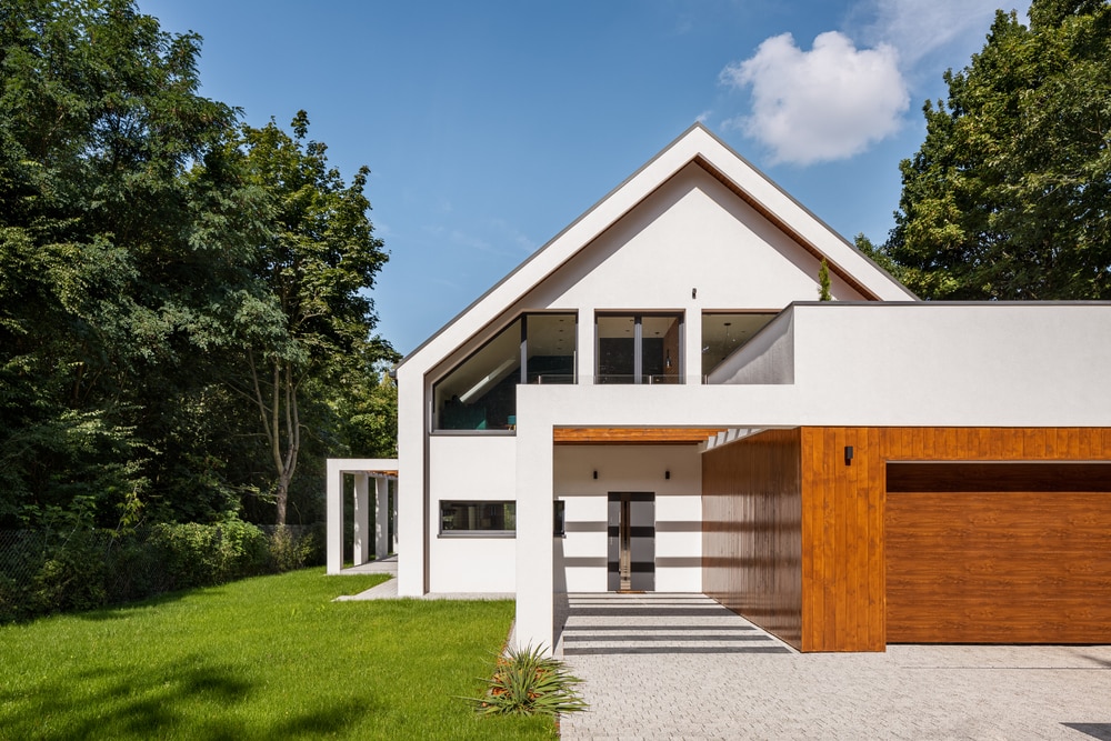 Two-story wood house with flat roof porch featuring cedar beams.