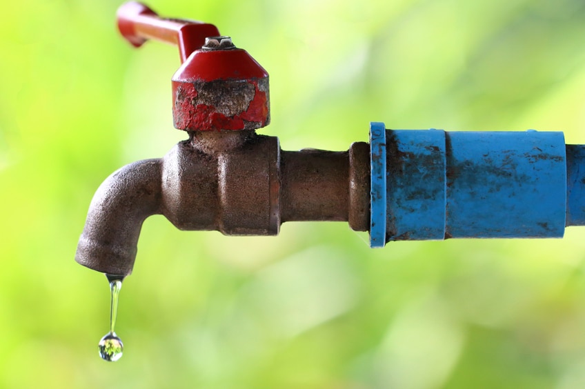 Water dripping out of a faucet