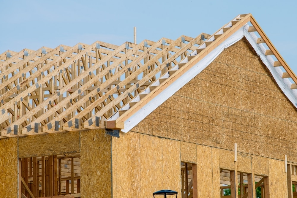 An unfinished house with exposed rafters.