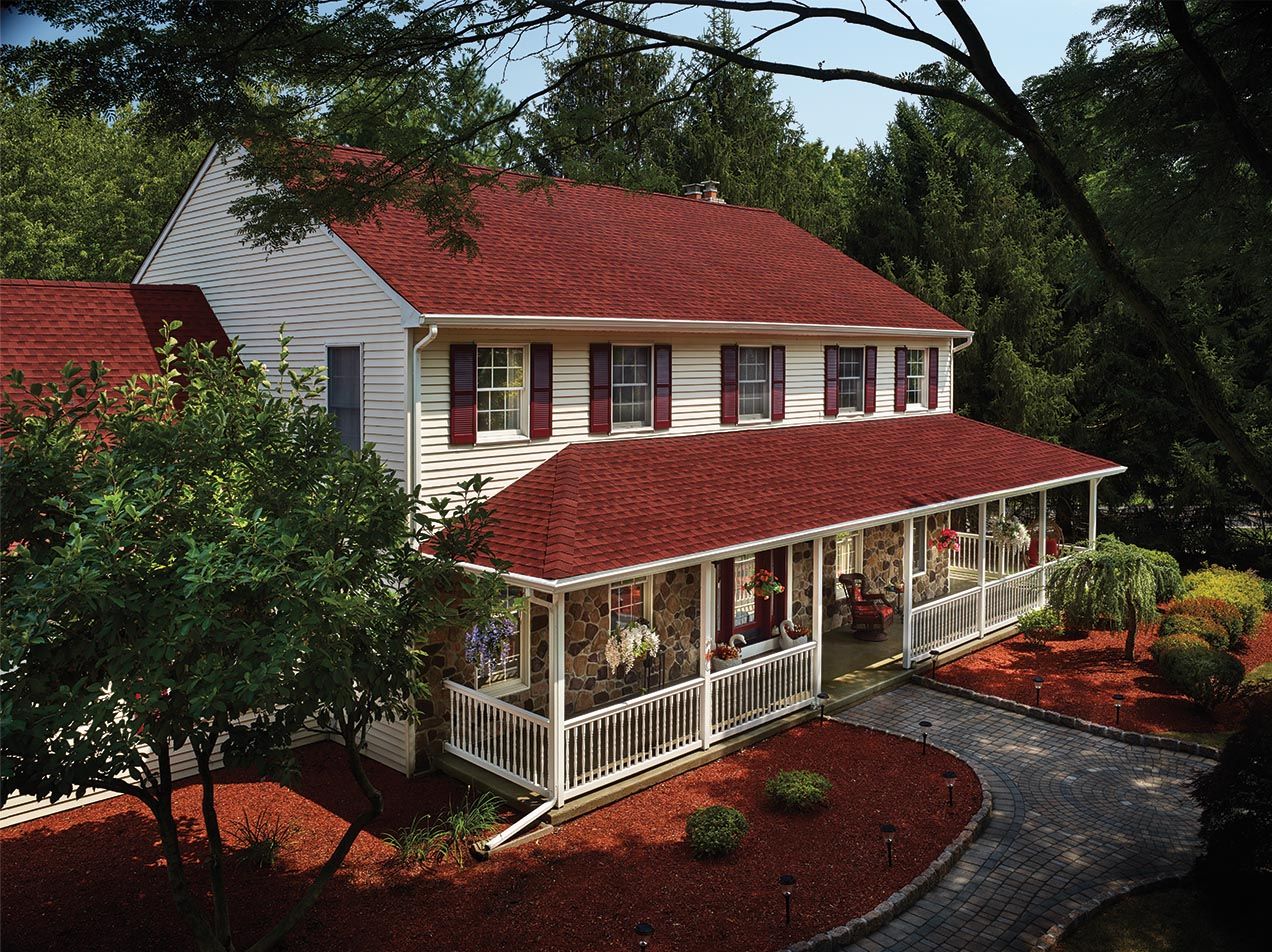 GAF's Timberline HDZ Patriot Red shingles on a two story white home.