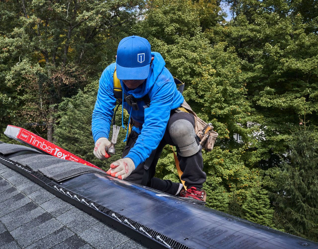 Finish installing roofing shingles with the ridge cap