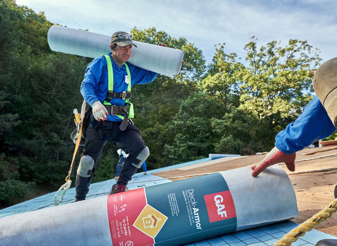 Intalling roof shingles includes laying underlayment.