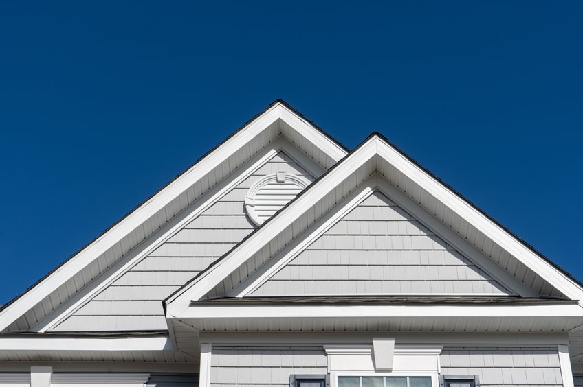 A double gable with a circular attic vent
